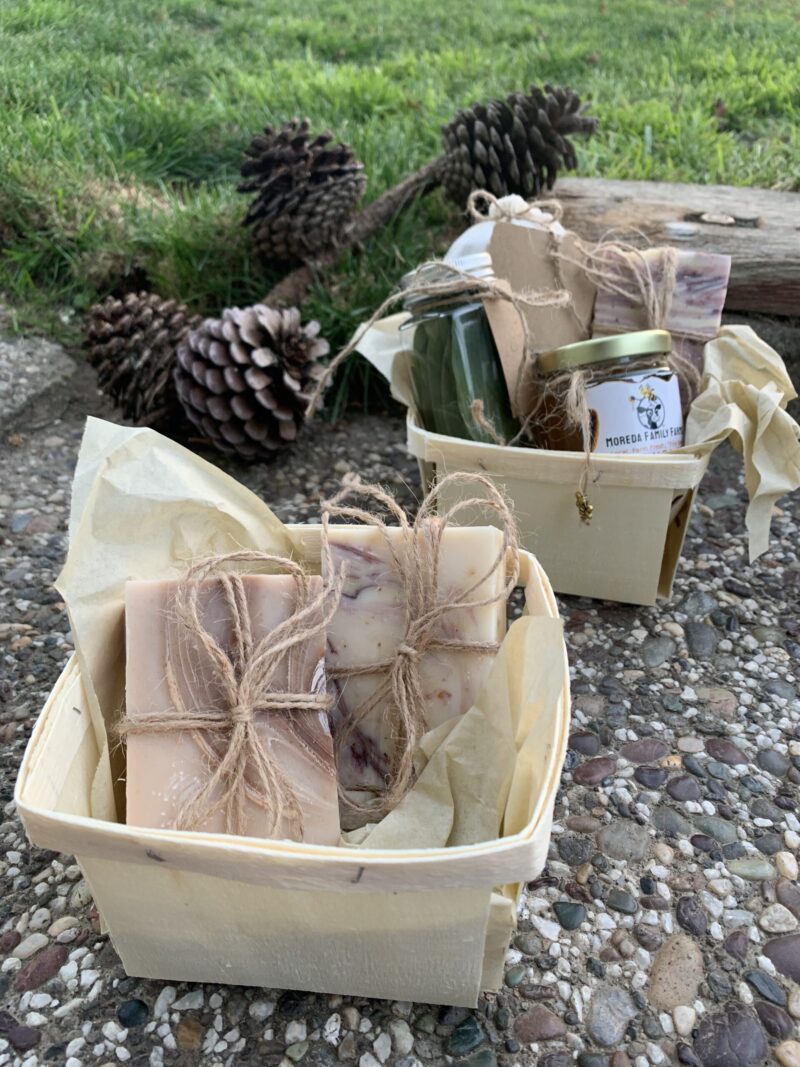 Gift Basket with Bay Leaves, Honey, Milk Soap, and Manure Tea (that one is for plants). Milk Soap Basket set up in front of the varied basket.